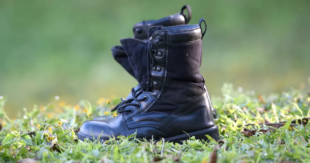 black combat boots on the grass