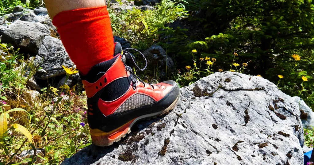 red hiking boots on a hike in the mountains of austria. activity during leisure time