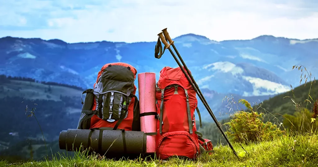 Hiking in the mountains in the summer with a backpack.