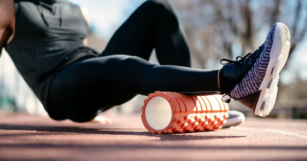 man-foam-rolling-athlete-stretches-using