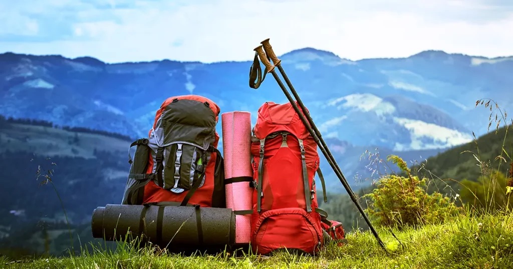 Hiking in the mountains in the summer with a backpack.