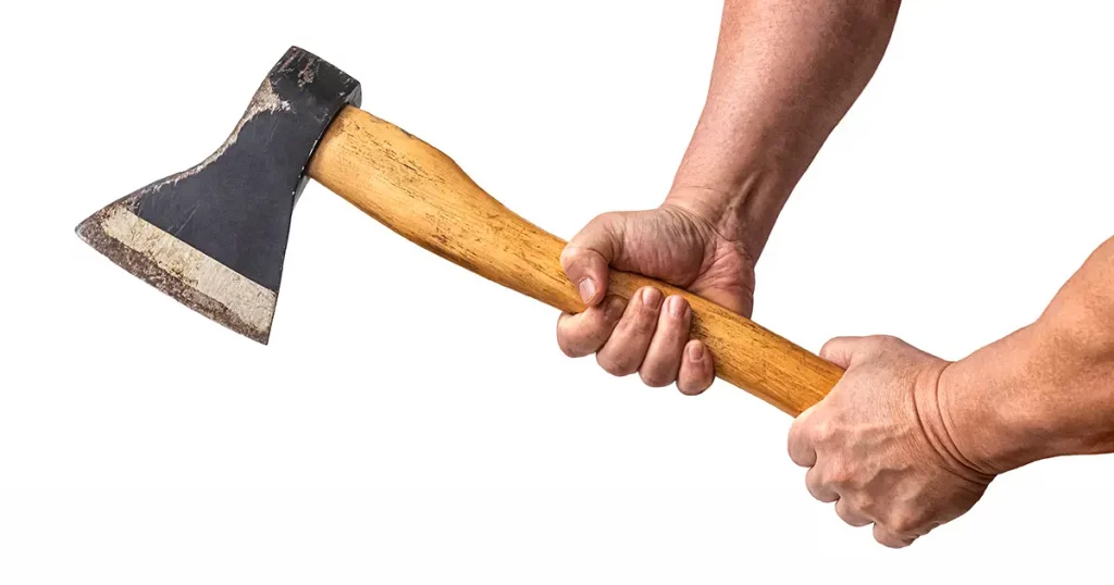 Carpenter's axe with a wooden handle in the hands of a working man, isolated on a white background