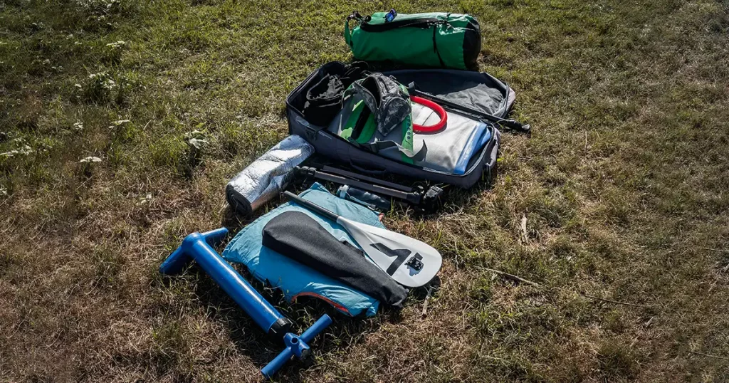 equipment for rafting on the river, an inflatable board and a paddle on the grass