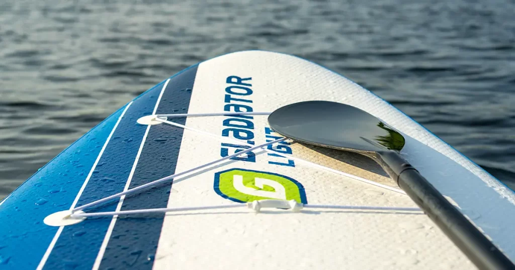 Inflatable Supboard with paddle on the surface of the water