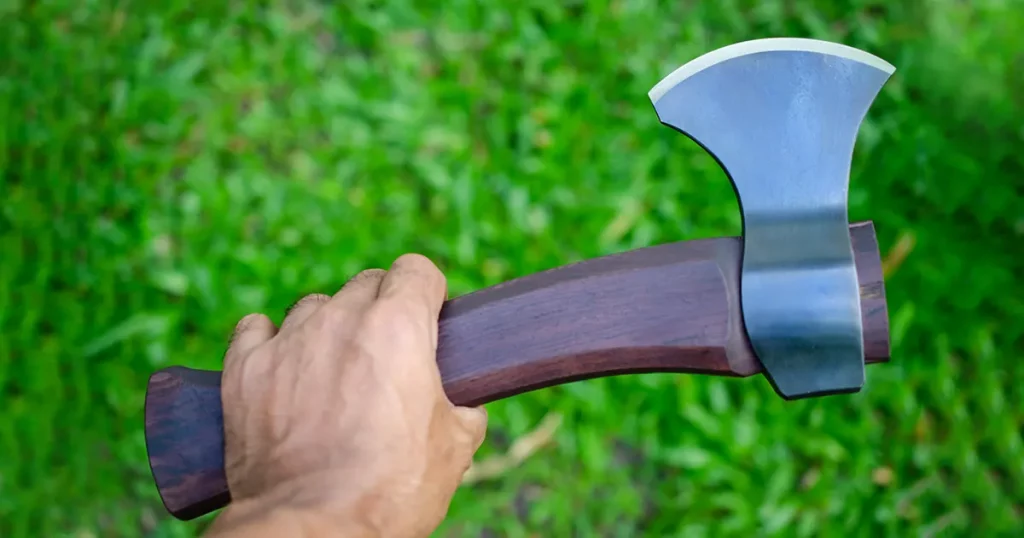 brown handle carving axe in hand