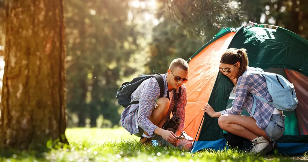 young-campers-setting-tent-forest