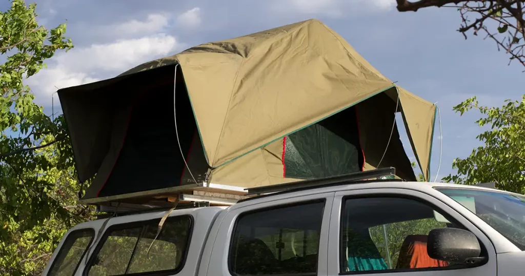 rooftop tent on a white pickup truck, ready for camping