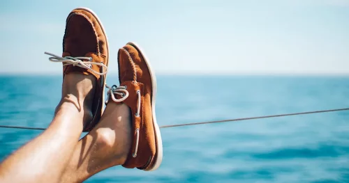 photo man legs on yacht wearing shoes