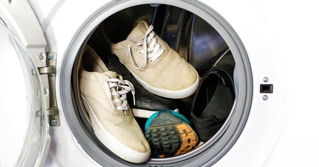 Many pairs of dirty sneakers in the washing machine
