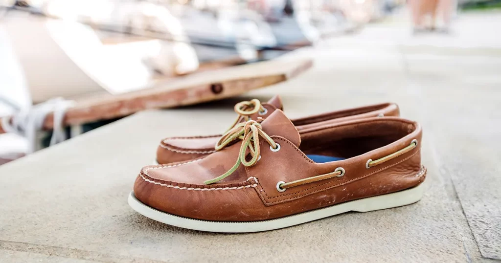 Mens brown loafers shoe on a pier head for Yacht Marina