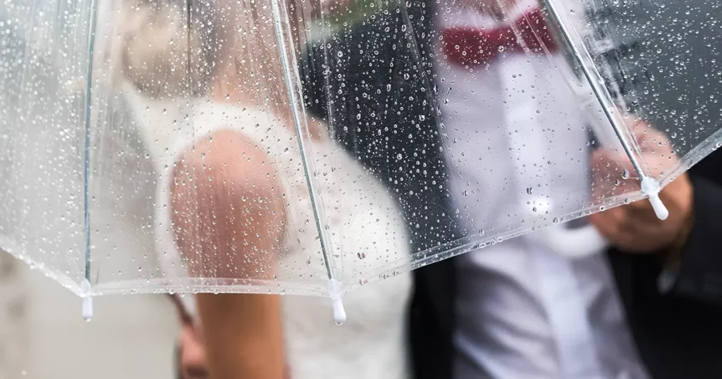 bride-groom-rain-covered-transparent-umbrella