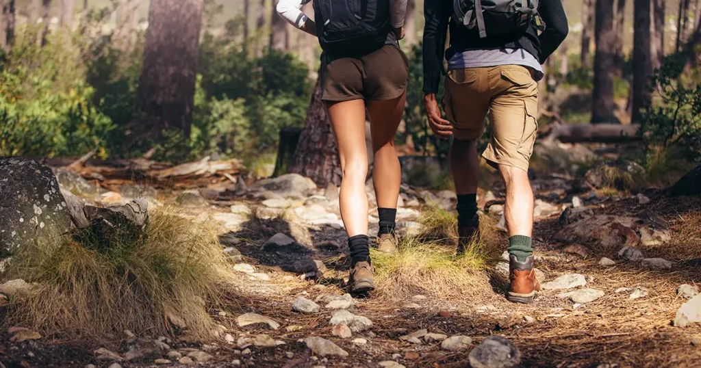 rear-view-man-woman-hikers-trekking