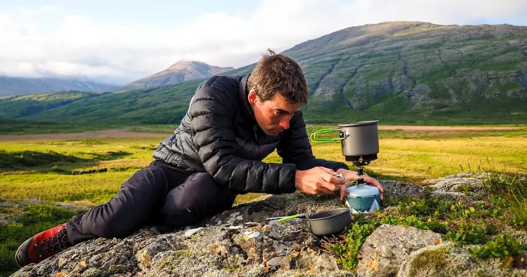 kettle boiling on a gas stove in the mountain camping