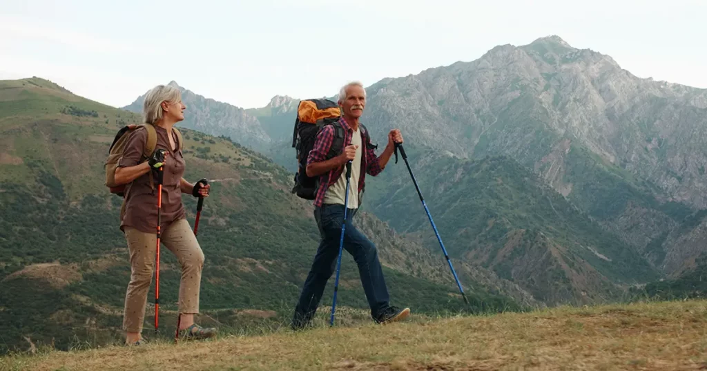 active-senior-caucasian-couple-hiking-mountains