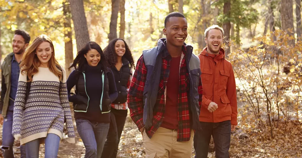 group-six-friends-hiking-together-through