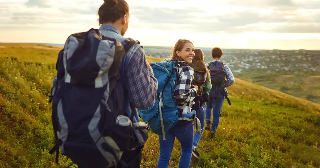 group-friends-trekking-backpacks-walking-forest