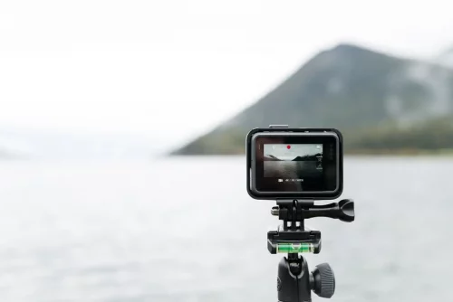 Camera equipment on a lake and mountain background