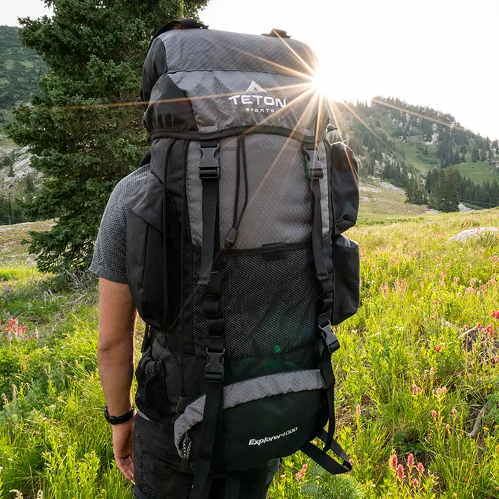 A man hiking with the Teton Sports Explorer 4000 backpack